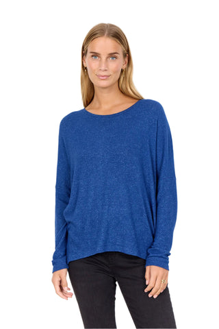 Woman wearing a blue sweater on a white background