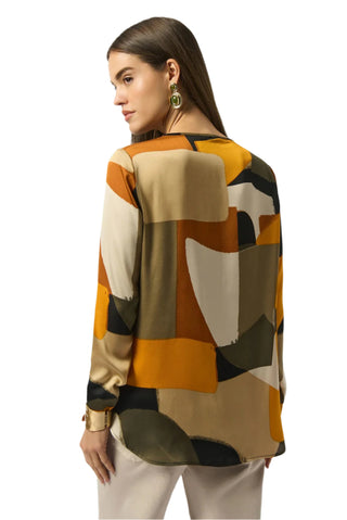 Woman wearing a patterned shirt with abstract design on a white background