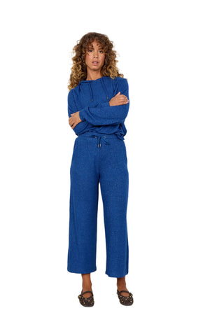 Woman wearing a blue outfit against a white background