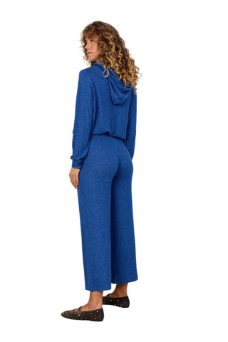 Woman wearing a blue outfit against a white background