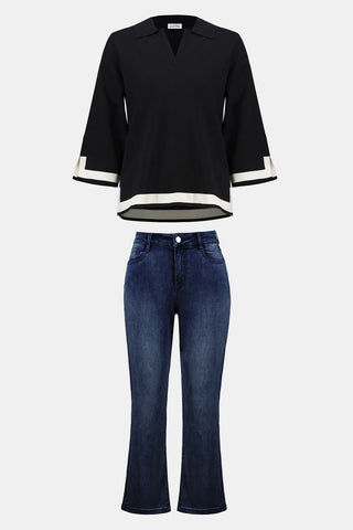 Black blouse with white trim and blue jeans on a white background