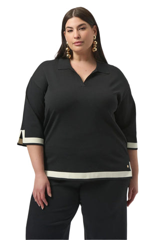 Woman wearing a black outfit with white trim on a white background