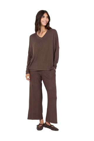 Woman wearing a brown outfit against a white background