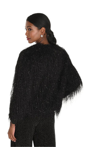 Woman wearing a black textured sweater on a white background