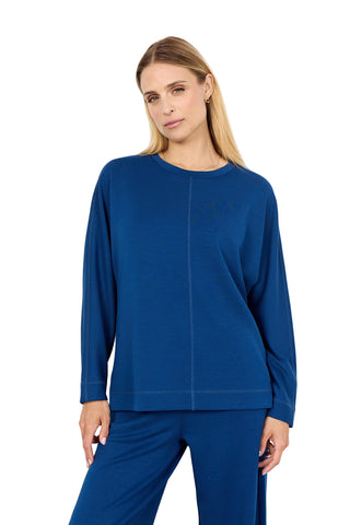 Woman wearing a blue outfit against a white background