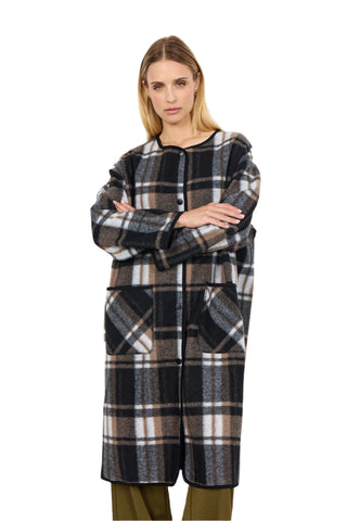 Woman wearing a plaid coat on a white background