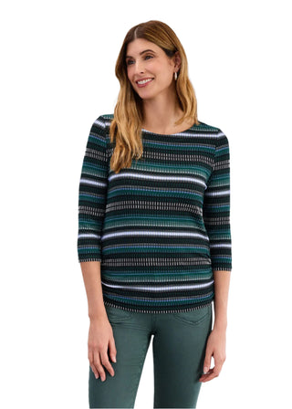 Woman wearing a striped sweater against a plain background