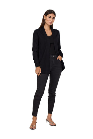Woman wearing a black outfit against a white background