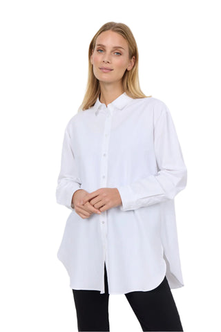 Woman wearing a white shirt against a plain background
