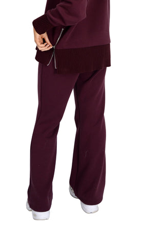 Maroon outfit with wide-leg pants and a matching top on a white background