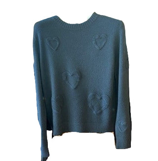 Dark gray sweater with heart patterns on a hanger in a store setting