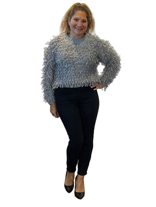 Woman posing in front of an 'Anne's on the Avenue' branded backdrop