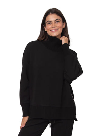 Woman wearing a black turtleneck sweater against a white background