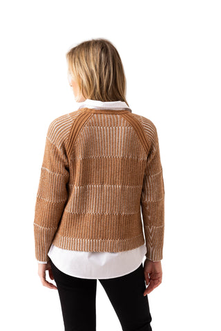 Woman wearing a brown patterned sweater on a white background