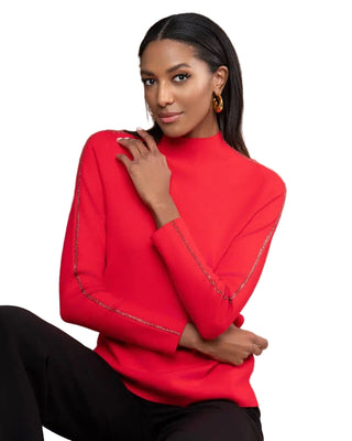 Woman wearing a red sweater with a wooden panel background