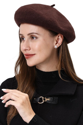 Woman wearing a brown beret and black coat on a white background