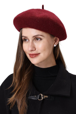 Woman wearing a red beret against a white background