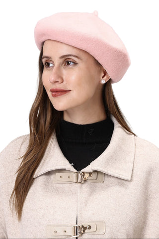 Woman wearing a pink beret and beige coat against a light background
