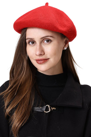 Woman wearing a red beret and black coat against a white background