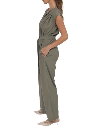 Woman wearing a green jumpsuit on a white background