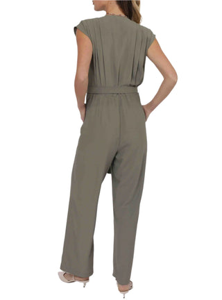 Person wearing a green jumpsuit on a white background