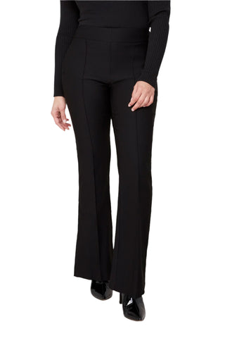 Person wearing black flared pants and a black top on a white background