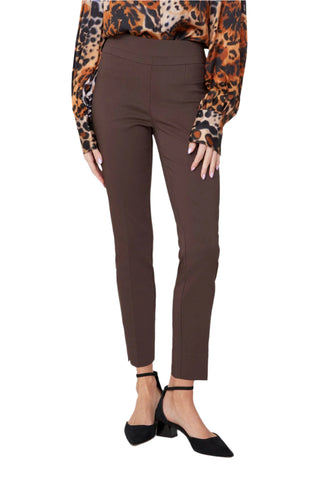 Person wearing brown pants with a leopard print top on a white background