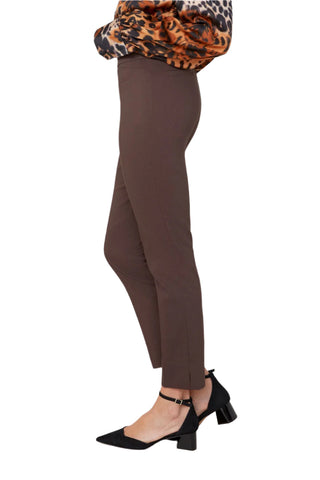 Brown pants worn with a leopard print top on a plain background