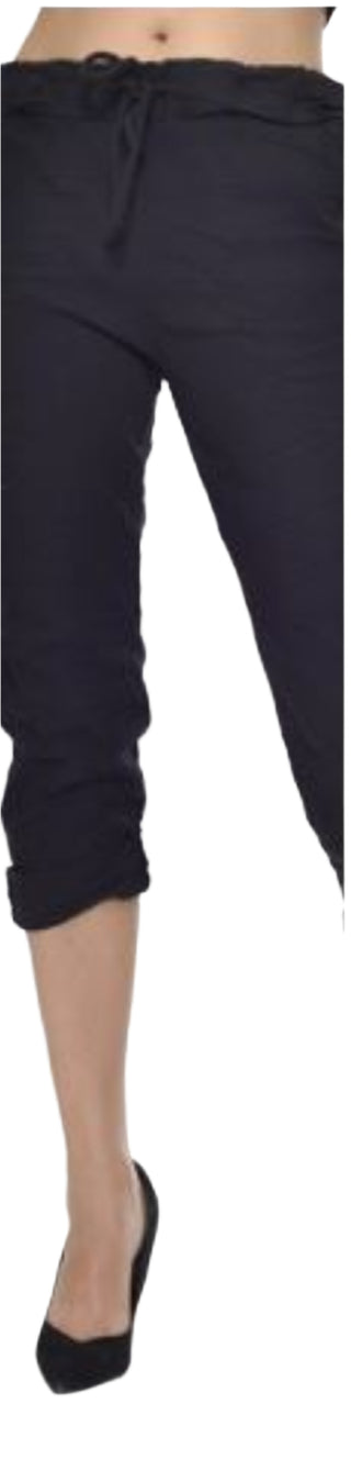 Black capri pants worn by a person on a white background