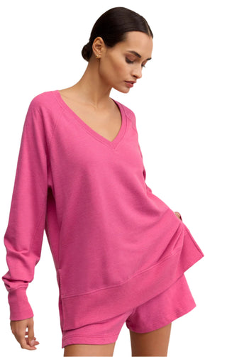 Woman wearing a pink outfit on a beige background