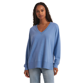 Woman wearing a blue sweater against a white background