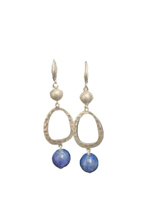 Silver hoop earrings with blue beads on a Merx branded card against a black background