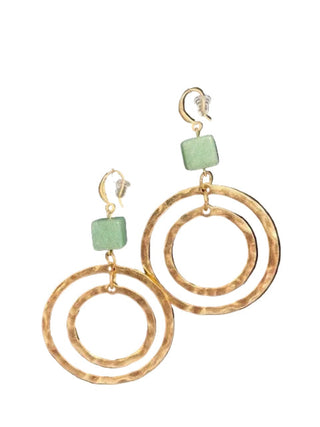 Gold hoop earrings with green beads on a dark background