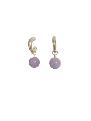 Pair of earrings on a MERX branded card against a dark background