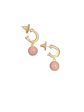 Gold hoop earrings with pink spherical charms on a black background