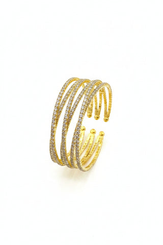 Gold bracelet on a textured stone surface