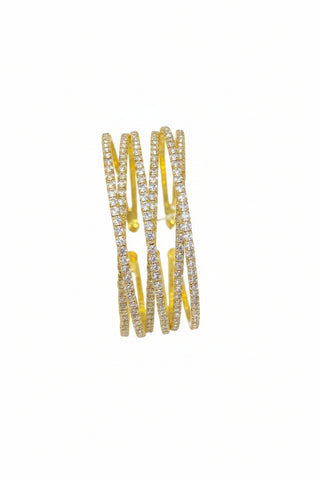 Gold bracelet with clear stones on a brown surface