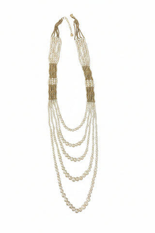 Multi-layered pearl necklace on a marble surface