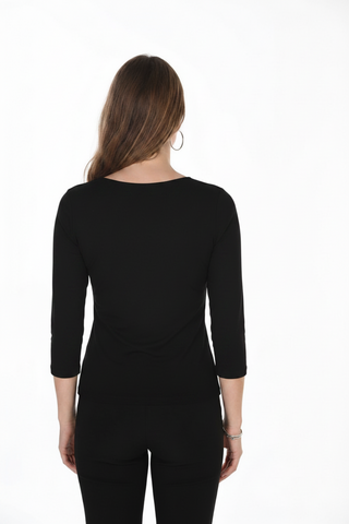 A woman viewed from the back wearing a black three-quarter sleeve top and black pants against a plain white studio background.