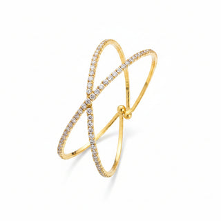 Gold bracelet with small stones on a textured stone surface