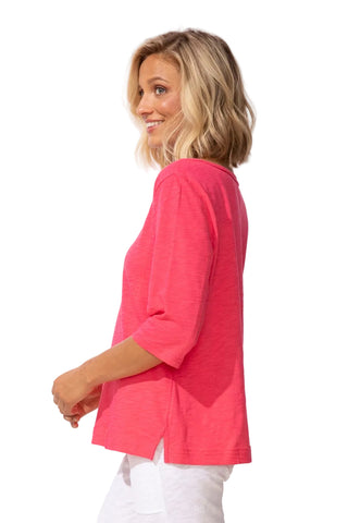 Woman wearing a pink top on a white background