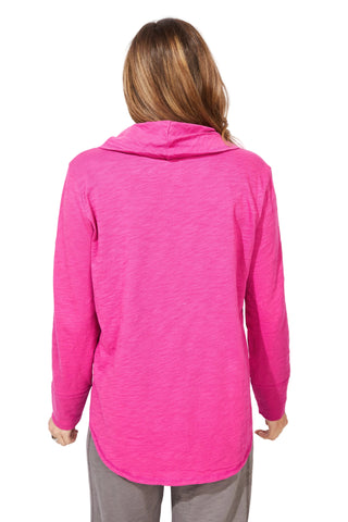 Person wearing a bright pink long-sleeve top against a white background