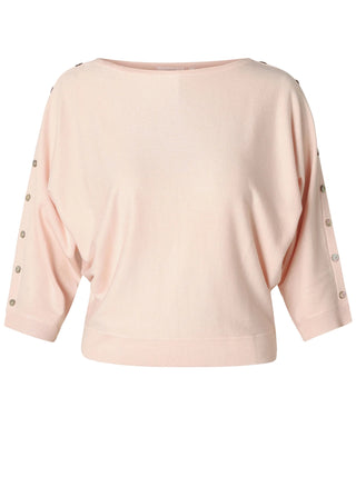 Pink blouse with button details on sleeves against a white background