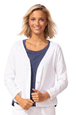 Woman wearing a white cardigan over a blue shirt on a white background