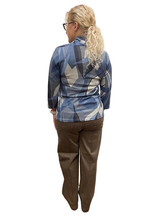 Person wearing a blue patterned shirt and brown pants standing in a fitting room.