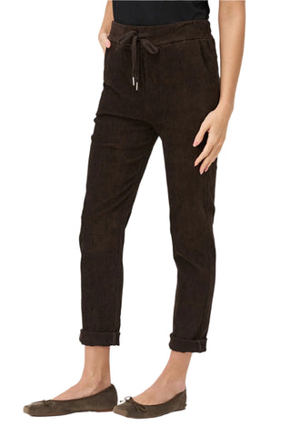 Brown pants worn by a person on a white background