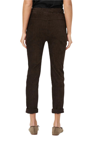 Brown pants worn by a person on a white background