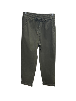 Green pants on a hanger against a white background