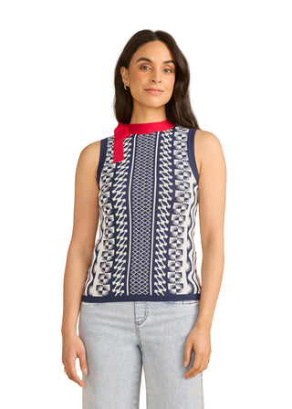 Woman wearing a sleeveless patterned top with a red scarf against a beige background