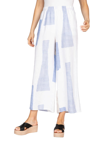 White pants with blue geometric patterns worn by a person on a white background